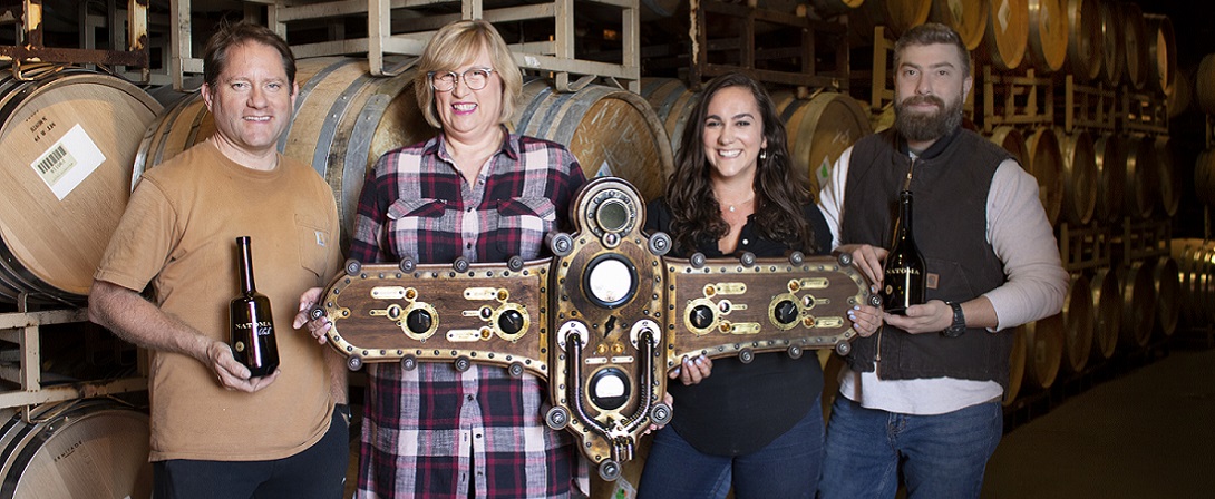 Four Willamette Valley Vineyards team members collaborated to create this experience, where individual varieties continue to develope in barrel allowing customers to blend their own, one-of-a-kind wines. Pictured Left to right: Kyle Gunsul, technical developer; Kathy Shannon, steam punk decor advisor; Laurel Titus, project manager; and Brandon Shelby, wine production manager.